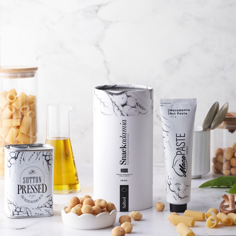 Premier Nut range — Sutton Pressed macadamia oil, Snackadamia and Macadamia Nut Paste styled on marble.